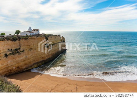 Natural caves and beach, Algarve Portugal. Rock cliff arches of Seven Hanging Valleys and turquoise sea water on coast of Portugal in Algarve region Natural caves and beach, Algarve Portugal. Rock cliff arches of Seven Hanging Valleys and turquoise sea water on coast of Portugal in Algarve region 98298774