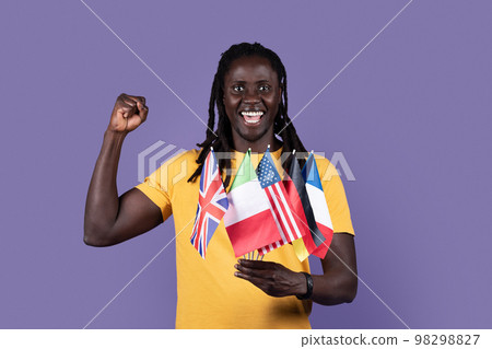 Emotional african american guy holding diverse flags and gesturing 98298827