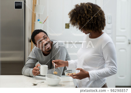 Happy african american couple having breakfast at home Happy african american couple having breakfast at home 98298857
