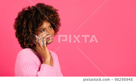 Happy pensive millennial african american curly woman in casual call by phone, look at copy space 98298948