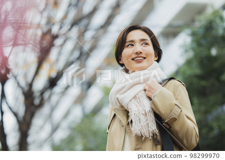 Winter woman walking outdoors 98299970