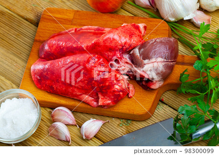 Cooking lamb lungs and liver with parsley and garlic on the table Cooking lamb lungs and liver with parsley and garlic on the table 98300099