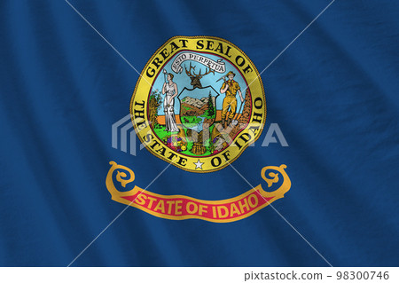 Idaho US state flag with big folds waving close up under the studio light indoors. The official symbols and colors in banner 98300746