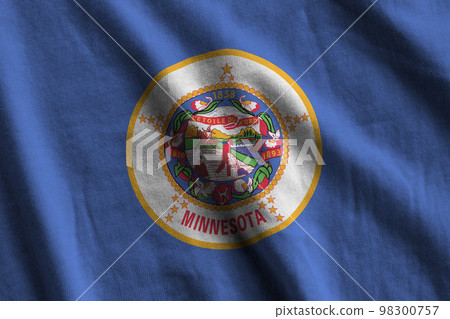 Minnesota US state flag with big folds waving close up under the studio light indoors. The official symbols and colors in banner Minnesota US state flag with big folds waving close up under the studio light indoors. The official symbols and colors in banner 98300757