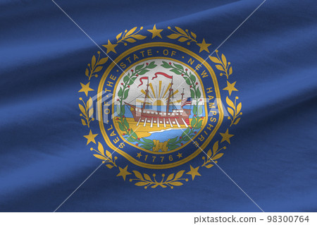 New Hampshire US state flag with big folds waving close up under the studio light indoors. The official symbols and colors in banner New Hampshire US state flag with big folds waving close up under the studio light indoors. The official symbols and colors in banner 98300764