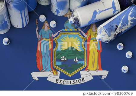 New York US state flag and few used aerosol spray cans for graffiti painting. Street art culture concept 98300769