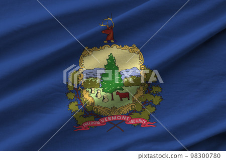 Vermont US state flag with big folds waving close up under the studio light indoors. The official symbols and colors in banner Vermont US state flag with big folds waving close up under the studio light indoors. The official symbols and colors in banner 98300780