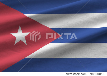 Cuba flag with big folds waving close up under the studio light indoors. The official symbols and colors in banner Cuba flag with big folds waving close up under the studio light indoors. The official symbols and colors in banner 98300846