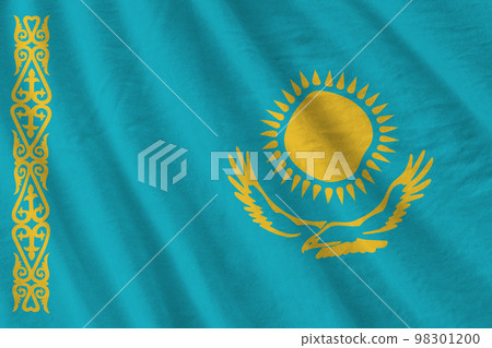 Kazakhstan flag with big folds waving close up under the studio light indoors. The official symbols and colors in banner 98301200