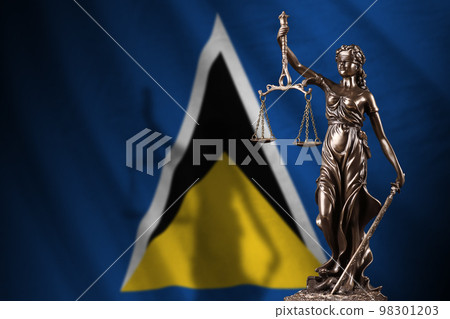 Saint Lucia flag with statue of lady justice and judicial scales in dark room. Concept of judgement and punishment 98301203
