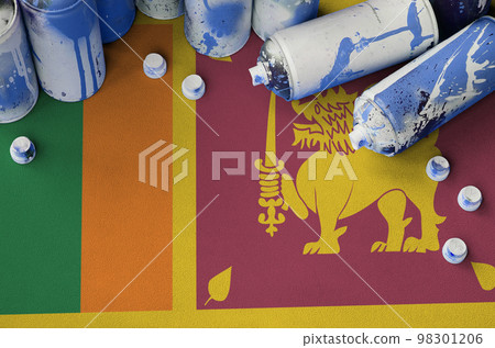 Sri Lanka flag and few used aerosol spray cans for graffiti painting. Street art culture concept Sri Lanka flag and few used aerosol spray cans for graffiti painting. Street art culture concept 98301206
