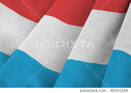 Luxembourg flag with big folds waving close up under the studio light indoors. The official symbols and colors in banner 98301209