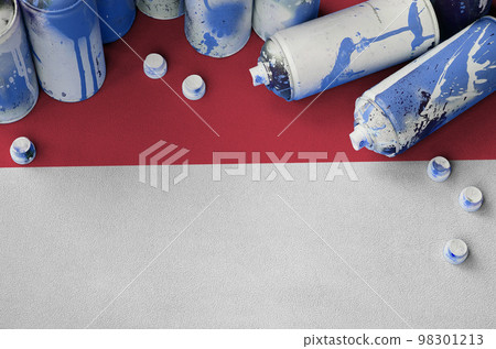 Monaco flag and few used aerosol spray cans for graffiti painting. Street art culture concept Monaco flag and few used aerosol spray cans for graffiti painting. Street art culture concept 98301213