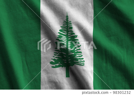 Norfolk island flag with big folds waving close up under the studio light indoors. The official symbols and colors in banner 98301232
