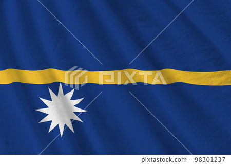 Nauru flag with big folds waving close up under the studio light indoors. The official symbols and colors in banner 98301237