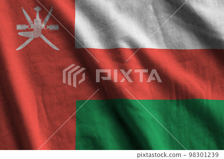 Oman flag with big folds waving close up under the studio light indoors. The official symbols and colors in banner Oman flag with big folds waving close up under the studio light indoors. The official symbols and colors in banner 98301239