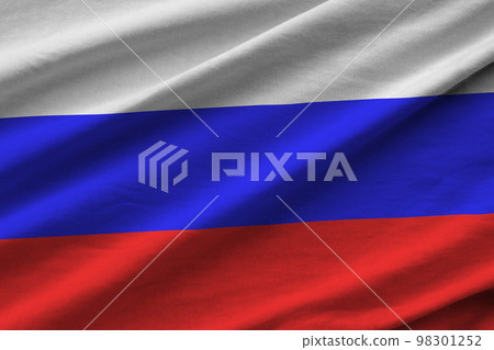 Russia flag with big folds waving close up under the studio light indoors. The official symbols and colors in banner Russia flag with big folds waving close up under the studio light indoors. The official symbols and colors in banner 98301252