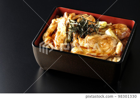 A black background of grilled long green onion and yakitori-ju with plenty of sauce 98301330