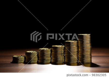 gold coins stacked in steps 98302305