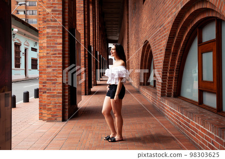 Beautiful young woman at the historical center of the city of Cali in Colombia Beautiful young woman at the historical center of the city of Cali in Colombia 98303625