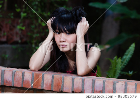 Taiwanese Chinese young woman looking sad 98305579