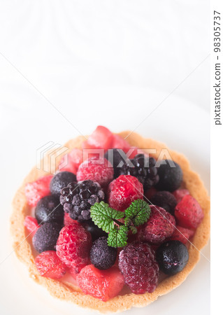 Cream cheese tart topped with frozen berries Cream cheese tart topped with frozen berries 98305737