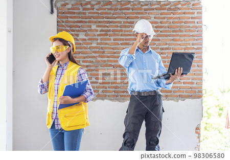 Civil engineer teams meeting working together wear worker helmets hardhat on construction site in modern city. Foreman industry project manager engineer teamwork. Asian industry professional team Civil engineer teams meeting working together wear worker helmets hardhat on construction site in modern city. Foreman industry project manager engineer teamwork. Asian industry professional team 98306580