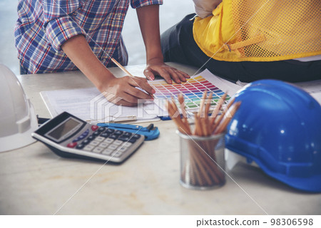 Civil Construction engineer teams shaking hands together wear work helmets worker on construction site. Foreman industry project working engineer teamwork. Two asian engineer team shake hands together 98306598