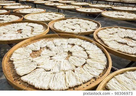 Close-up of traditional handmade noodle-making drying outdoors in Guanmiao, Tainan, Taiwan. Close-up of traditional handmade noodle-making drying outdoors in Guanmiao, Tainan, Taiwan. 98306973