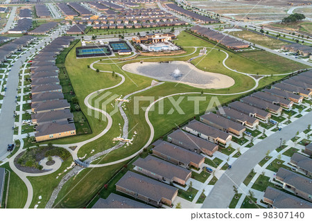 Drone top view of streets with lots houses and green lawn in the summertime outdoor 98307140