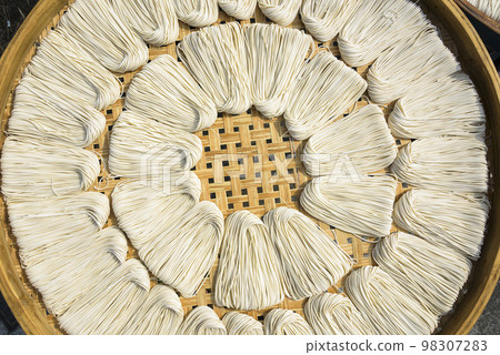 Close-up of traditional handmade noodle-making drying outdoors in Guanmiao, Tainan, Taiwan. 98307283