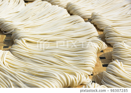 Close-up of traditional handmade noodle-making drying outdoors in Guanmiao, Tainan, Taiwan. Close-up of traditional handmade noodle-making drying outdoors in Guanmiao, Tainan, Taiwan. 98307285
