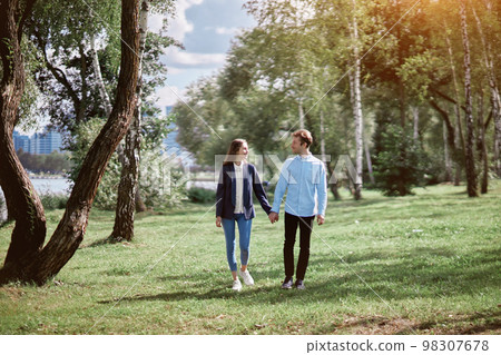 happy couple in love walking holding hands. 98307678