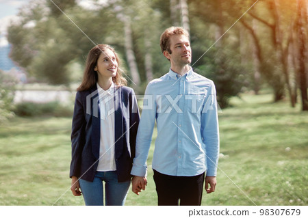 happy couple in love walking holding hands. 98307679