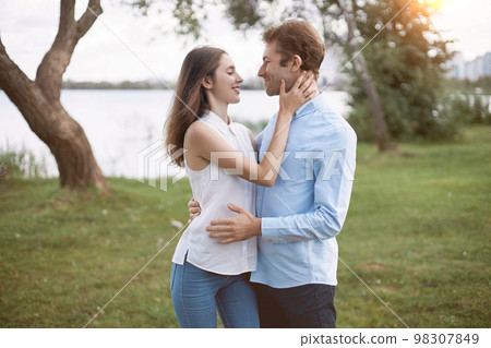 man and a woman in love tenderly looking at each other . 98307849