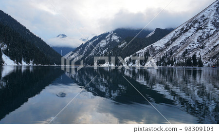 Kolsai mountain lake in the winter forest. Kolsai mountain lake in the winter forest. 98309103