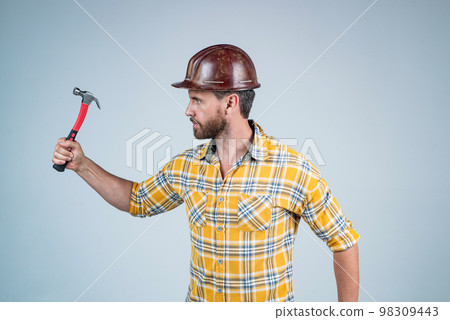 carry out repairs. man architect with hammer. guy wear worker uniform. handsome builder in helmet. mature man wear checkered shirt. professional constructor or mechanic. builder engineer carry out repairs. man architect with hammer. guy wear worker uniform. handsome builder in helmet. mature man wear checkered shirt. professional constructor or mechanic. builder engineer 98309443