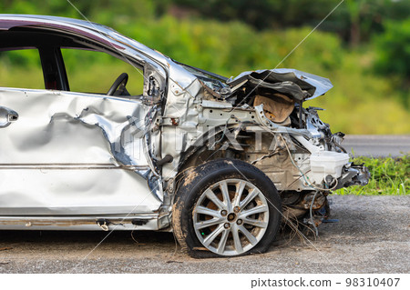 Silver car get hard damaged by accident on the road. Maintenance or car repair concept 98310407
