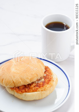 Have a light meal of coffee and a sandwich of Kaiser Semmel, an Austrian bread roll with a ham cutlet Have a light meal of coffee and a sandwich of Kaiser Semmel, an Austrian bread roll with a ham cutlet 98311126