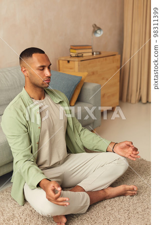 Calm Man Meditating Home. Multiracial Guy Sitting In Lotus Pose Practicing Yoga 98311399