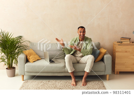 Happy Man Pointing Palms At Home. Positive Guy Paying Your Attention 98311401