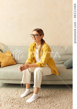 Happy Woman Relaxing Sofa. Smiling Girl Sitting On Comfortable Couch Happy Woman Relaxing Sofa. Smiling Girl Sitting On Comfortable Couch 98311484