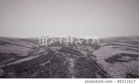 Dramatic winter dark desert steppe on a highland mountain plateau Dramatic winter dark desert steppe on a highland mountain plateau 98311627