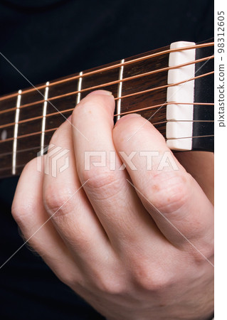 Playing black guitar guitar, hands close up Playing black guitar guitar, hands close up 98312605