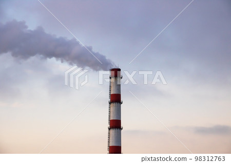 Gray smoke from the plant chimney at sunset 98312763