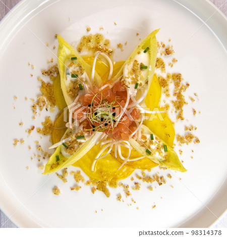 Recipe for salmon gravlax salad, endives filled with creame fresh, chives, yellow chioggia beetroot Recipe for salmon gravlax salad, endives filled with creame fresh, chives, yellow chioggia beetroot 98314378