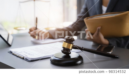 Lawyer women working on a monograph in courtroom. 98314532