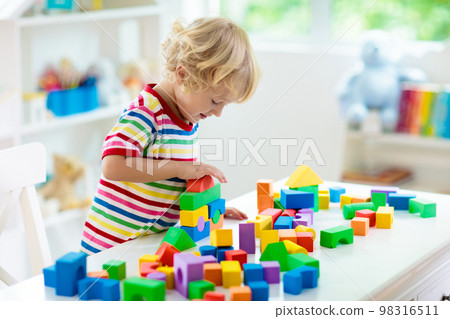 Kids toys. Child building tower of toy blocks. Kids toys. Child building tower of toy blocks. 98316511