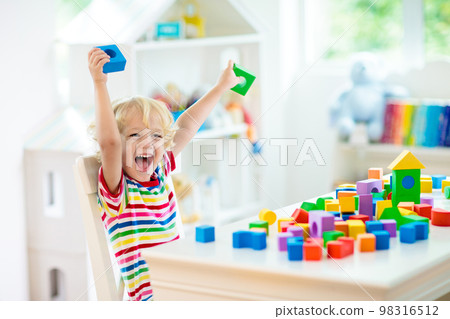 Kids toys. Child building tower of toy blocks. Kids toys. Child building tower of toy blocks. 98316512