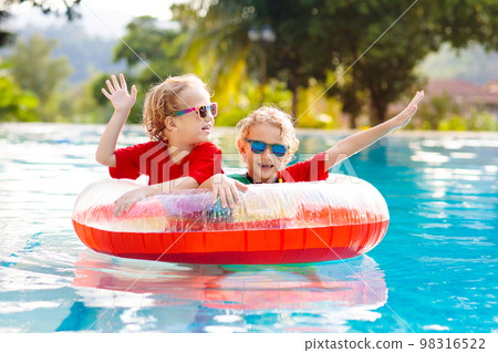 Kids in swimming pool. Life jacket for child. 98316522